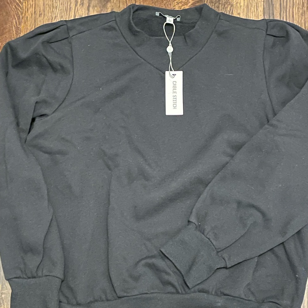 Black sweatshirt with puffy shoulder. Brand new.